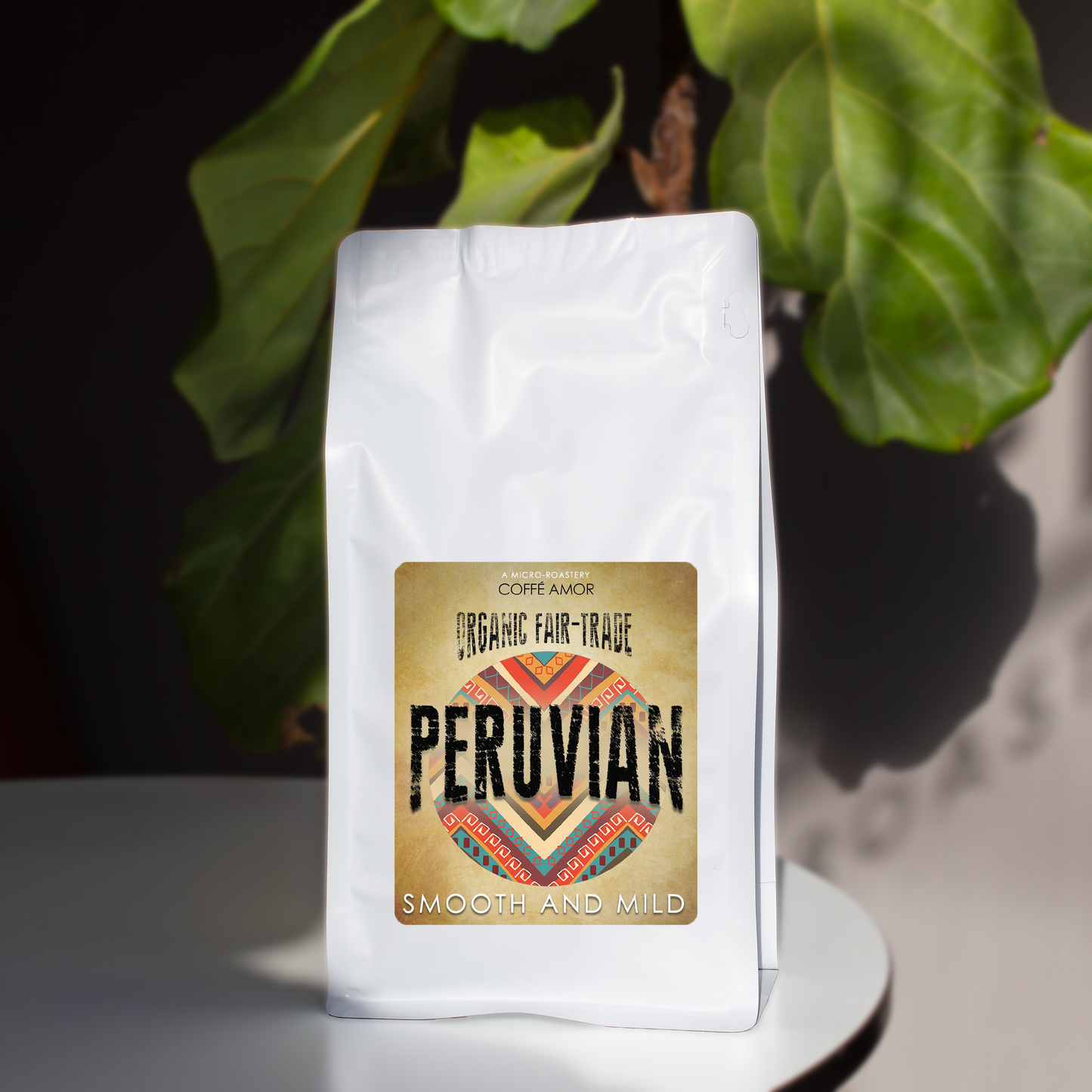 A bag of Coffe Amor organic fair trade coffee with the label 'PERUVIAN' prominently displayed, indicating smooth and mild flavor notes.