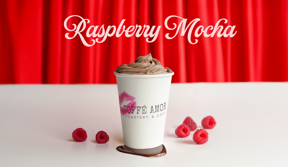 Raspberry Mocha coffee drink sitting on white table in front of red curtain background