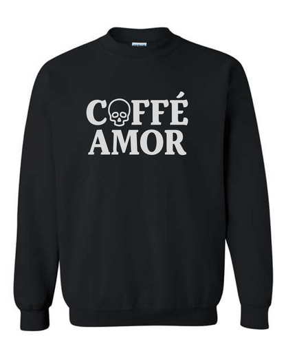A black crewneck sweatshirt with 'COFFÉ AMOR' printed in bold white letters across the chest, featuring a skull graphic inside the letter 'O'.